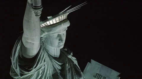 Close flight near Statue of Liberty at night Stock Footage