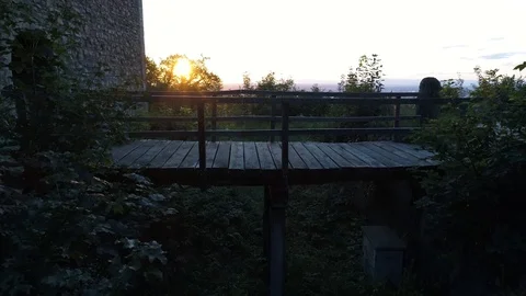 Close flight over wood bridge at ruin at sunset Stock Footage 90487345