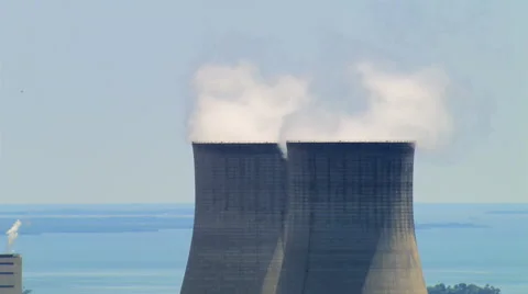 Close flight past nuclear cooling towers, with zoom-out Stock Footage