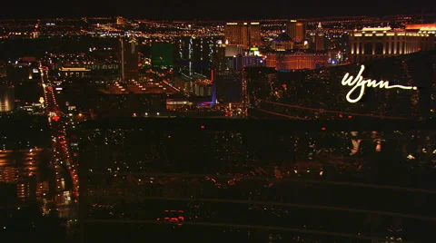 Close flight past the Wynn with wide view of Las Vegas cityscape at night. Shot Stock Footage 59515300
