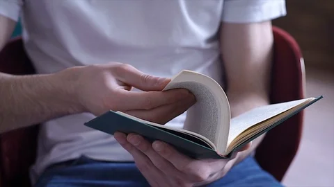 Close up flipping book in hands of man Stock Footage 105402977