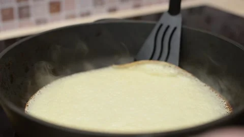 Close-up of flipping a pancake in a frying pan. Stock Footage 194566060