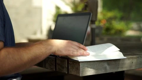Close up flipping through pages of book reading outside Stock Footage 241826420