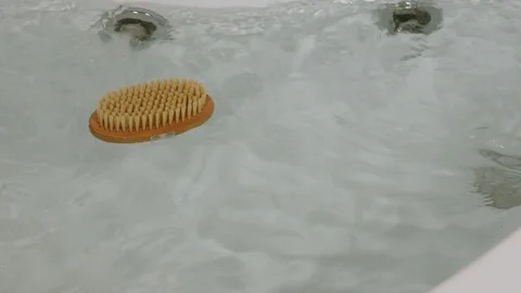 Close-up floating brush for a bath in the Jacuzzi Stock Footage 105659921