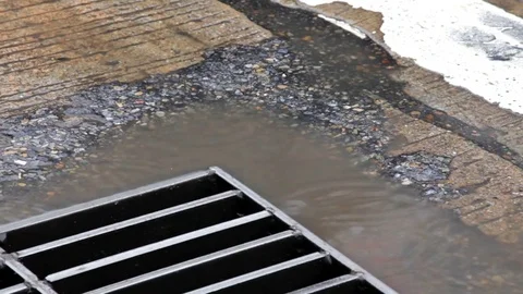 Close-up of flooding and drain in rainy day. Real time shot in city road. Stock Footage 77965837