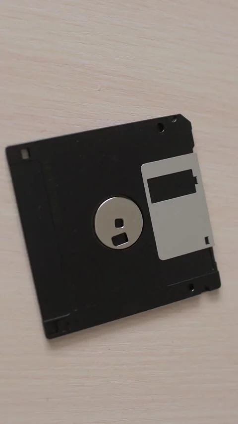Close-up of floppy disc. Obsolete computer technology. Vertical video. Stock Footage 270357892