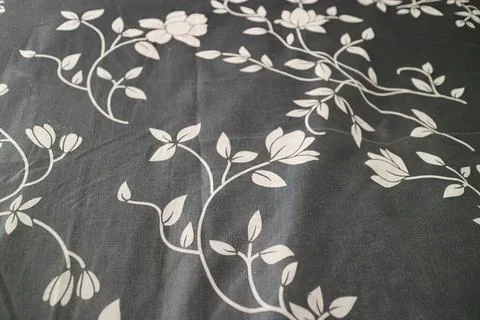 Close-up of floral pattern on dark fabric background Stock Photos