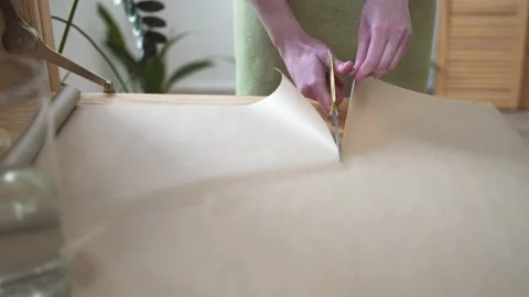 Close-up - the florist cuts the paper with scissors. The business owner works in Stock Footage 173162457