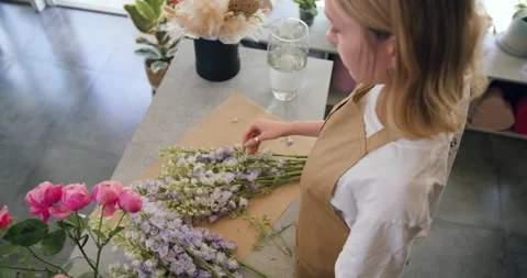 Close up florist hands working in flower shop studio. Female florist artist Stock Footage 203734960