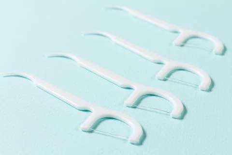 Close-up flossing toothpicks on the blue background Stock Photos