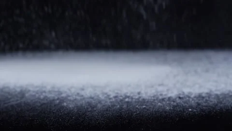 Close up on flour dropping on the black table top Video stock 156833125