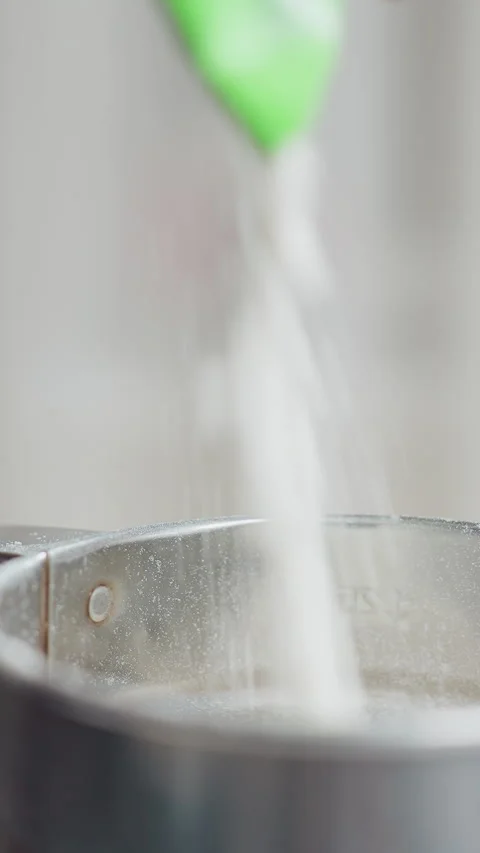 Close-Up of Flour Pouring Into Metal Cup for Baking Preparation Stock Footage 320339087