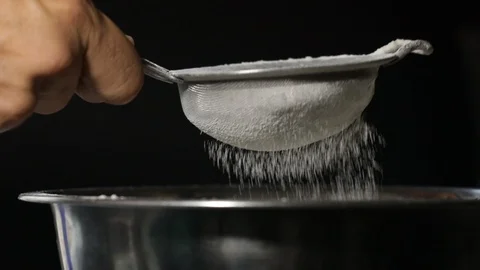 Close-up of flour through a sieve fray. Sifting flour baking Stock Footage 127796962