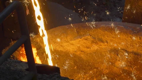 Close up on flow of hot liquid iron cast making sparkles Stock Footage 249620783