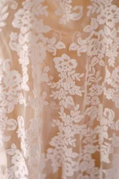 Close-up of a flower pattern of a white wedding bride dress with lining. Foto stock
