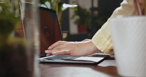 Close-up of flower shop worker using laptop to control growth of plants in Stock Footage 247842919