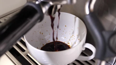 Close-up flowing fresh ground coffee. Pour coffee stream from the professional Stock Footage 256500395