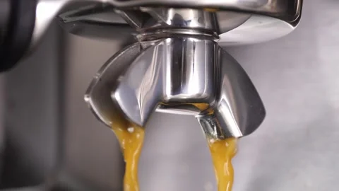 Close-up flowing fresh ground coffee. Pour coffee stream from the professional Stock Footage 256500426
