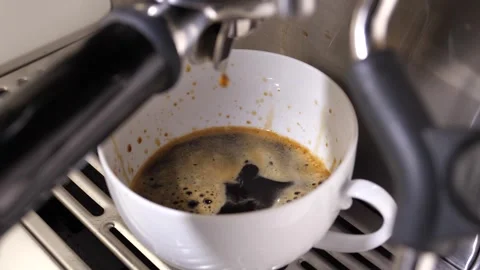 Close-up flowing fresh ground coffee. Pour coffee stream from the professional Stock Footage 257310199