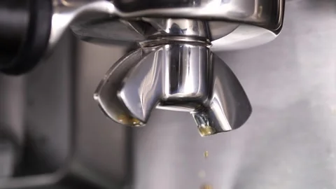 Close-up flowing fresh ground coffee. Pour coffee stream from the professional Stock Footage 257310247