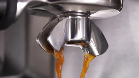Close-up flowing fresh ground coffee. Pour coffee stream from the professional Stock Footage 259753884