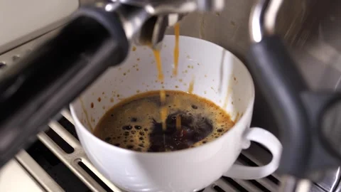 Close-up flowing fresh ground coffee. Pour coffee stream from the professional Stock Footage 263714489