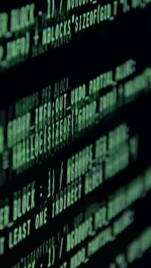 Close-up of flowing green code on a dark screen, showcasing intricate Stock Footage 323743164