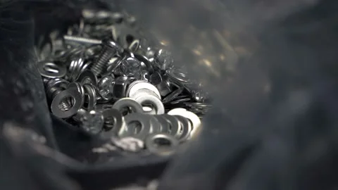 Close up of flowing inside of a clear plastic bag inside bolts, screws, washers. Stock Footage 219236698