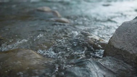 Close up of flowing stream water moving over mossy river rocks Stock Footage 341858524