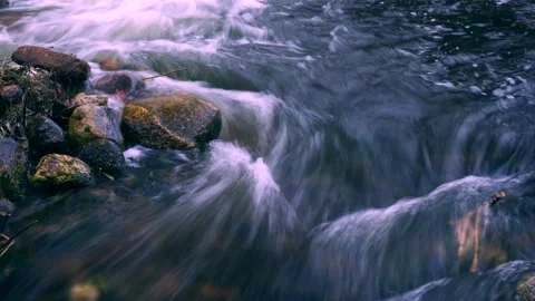 Close up of flowing water in mountain river. Time lapse footage. Stock Footage 155354331