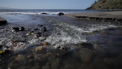 Close up on flowing water over rocks in a tropical cove Hawaii Stock Footage 90958614