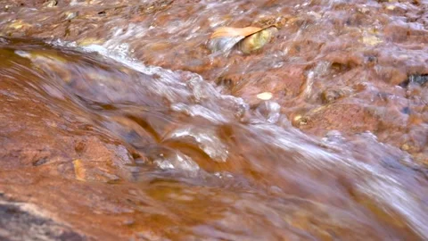 Close up of flowing water over rocks in natural stream Stock Footage 335883481