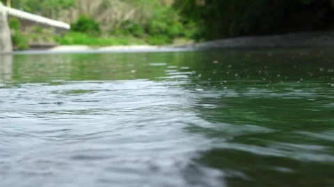 Close Up of the Flowing Water Surface with Shallow Depth of Field Stock Footage 334989035