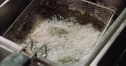 Close-up of fluidized roasting vegetables in oil on the fried food in the Stock Footage