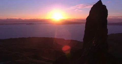 Close fly by Old Man Storr, looking into sunrise drone aerial 4K Stock Footage 104581864
