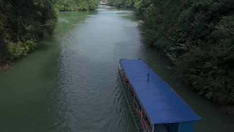 Close fly over of a jungle river cruise through a canyon in North Vietnam. Stock Footage 268239958