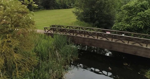 Close fly through trees over bridge and river with ducksdrone aerial 4k Stock Footage 114169954
