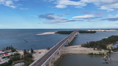 Close flyby of Thuan An Bridge tower aerial 4K Stock Footage 339860941