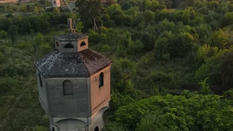 Close-up flying around the old abandoned water tower during sunset Stock Footage 138197535