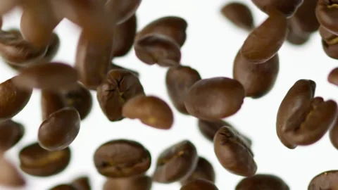 Close-up flying coffee beans on the white background slow motion Vídeo Stock 148552194