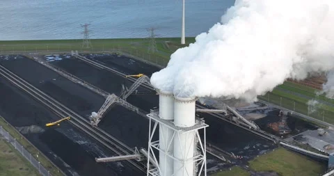 Close flying at the funnel of a coal and bio mass fired power plant. White Stock Footage 229652541