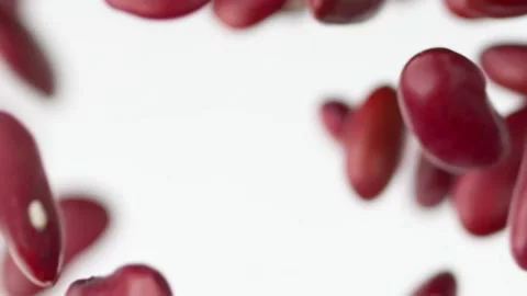 Close up flying red beans on the white background slow motion Video stock 148552434