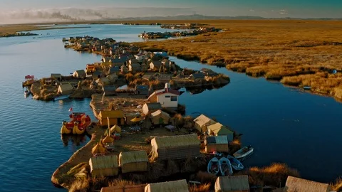 Close Flyover of Uros Floating Islands on Lake Titicaca at Sunset Stock Footage 115092084
