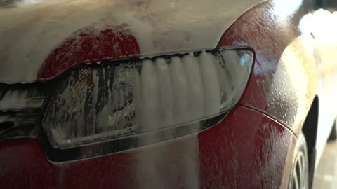 Close-up Foam Dripping From Headlights During Car Wash, Day Video stock 148101412