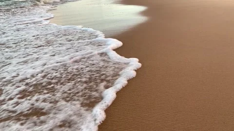 Close-up of the foam of sea waves on the beach sand Stock Footage 270484007