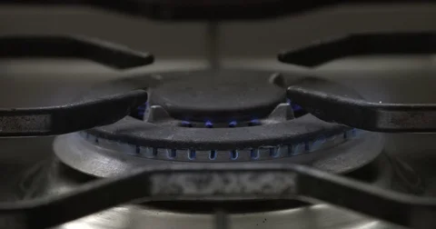 Close focus on big central gas hob and a pan put on it Video stock 75192891