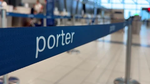 Close-up focus on blue Porter Airlines stanchion queue belt line Video stock 342578391