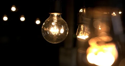 Close focus bokeh of light bulbs in a dark room Stock Footage 98357289