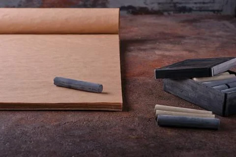 Close-up focus on a dark gray crayon for drawing on a craft album sheet, othe 写真素材