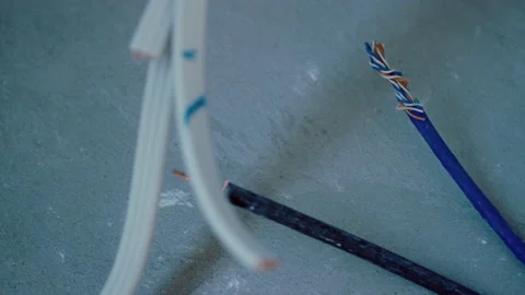 Close up focus pull from data cable to electrical cable Stock Footage 165479605